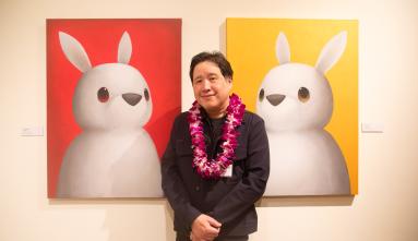luke chueh in front of his art